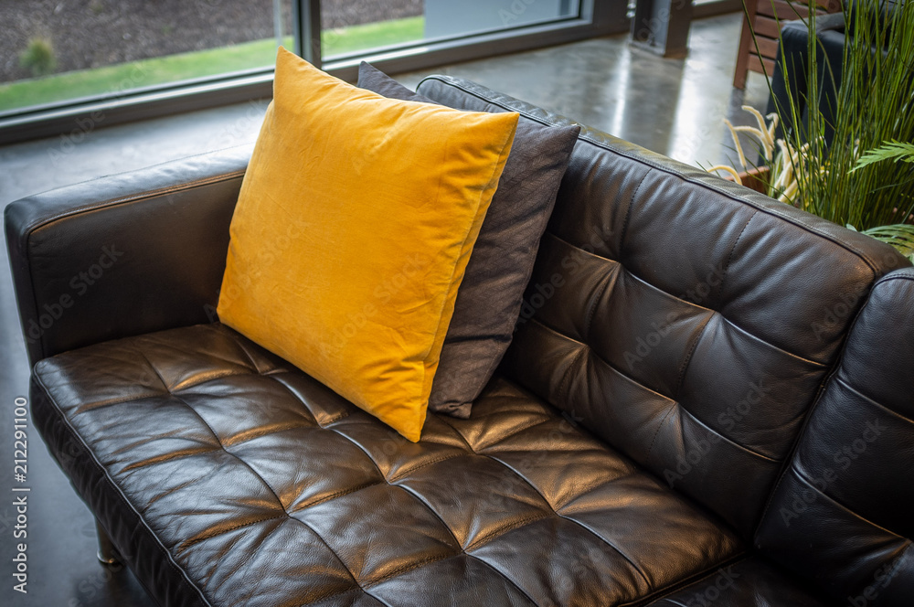 Pillows on black leather couch interior design sample Stock Photo Adobe Stock