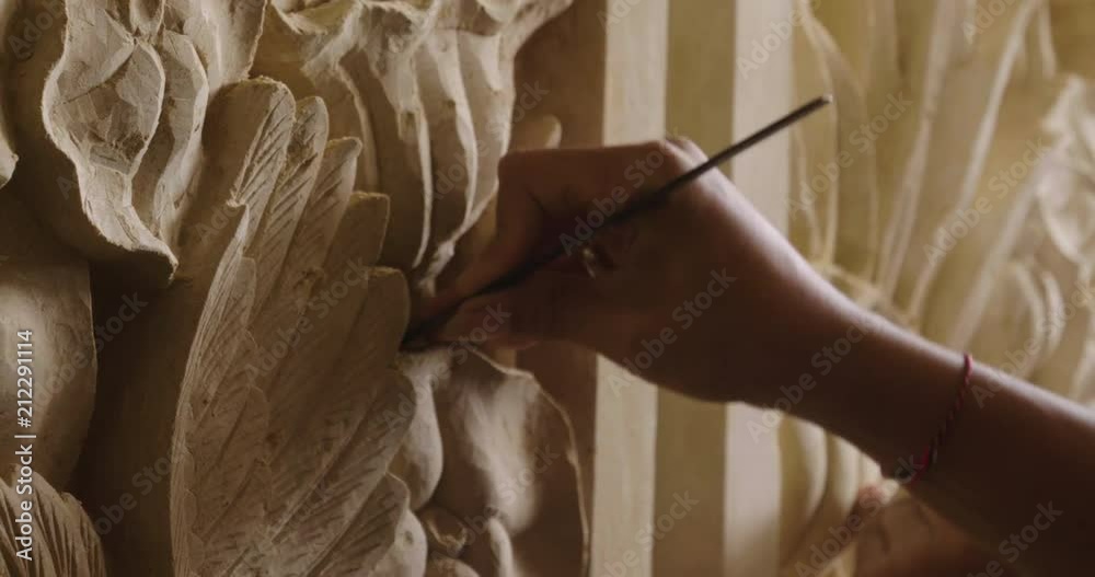 An artisan creates sculptures with chalk to make statues and works of