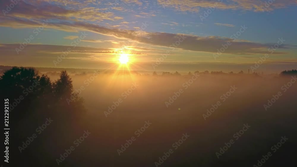 Beautiful aerial shot of thick layer of fog on fields during sunrise with expanse and endless skyline Beautiful aerial shot of thick layer of fog on fields during sunrise with expanse and endless skyline