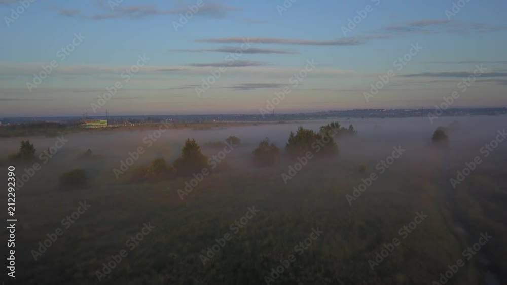 Beautiful aerial shot of thick layer of fog on fields during sunrise with expanse and endless skyline Beautiful aerial shot of thick layer of fog on fields during sunrise with expanse and endless skyline