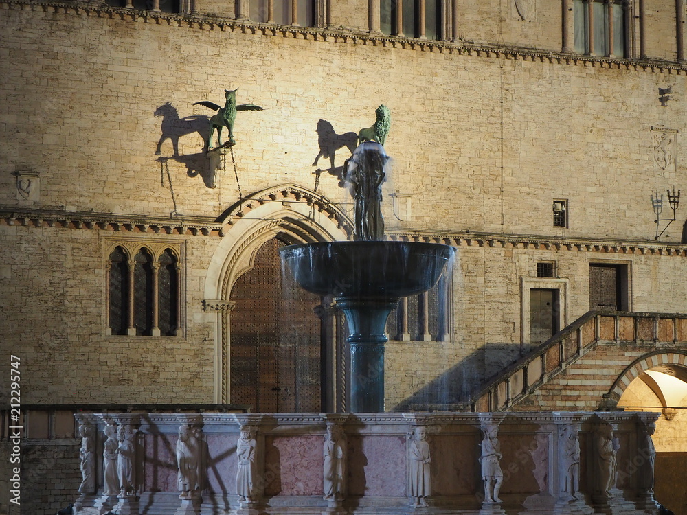 Fototapeta premium Perugia, Italy. Views of the Palazzo dei Priori an historical building of the town and the Fontana Maggiore a monumental medieval fountain