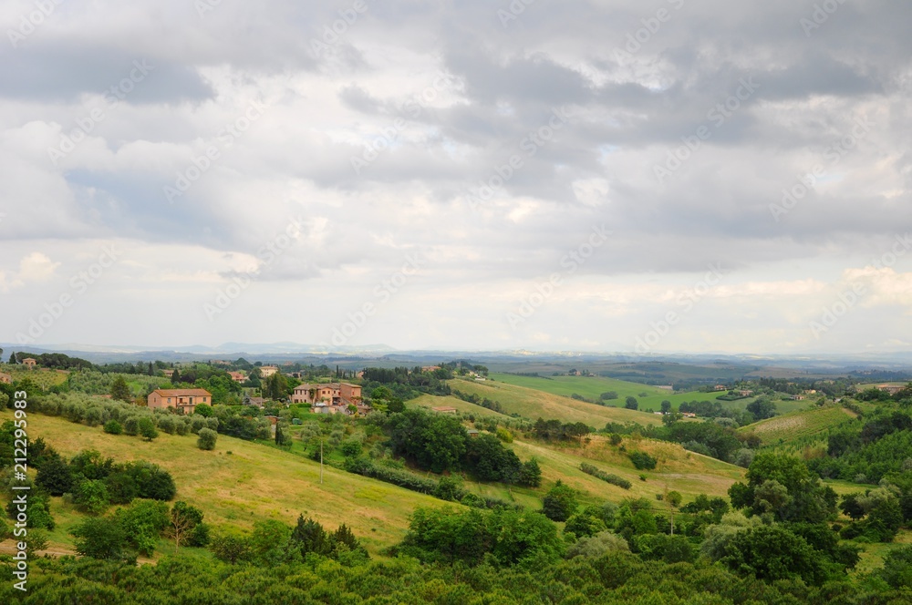 Beautiful landscape of hills, cypress trees and houses in Tuscany, Italy