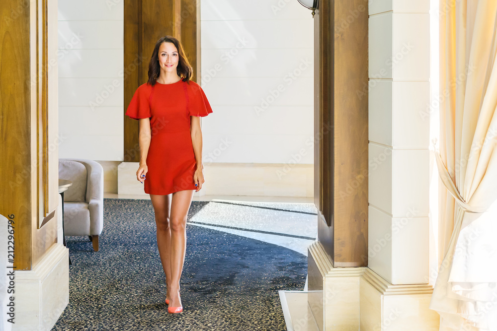 A young girl is walking around the hall. A young girl is walking around the hall.