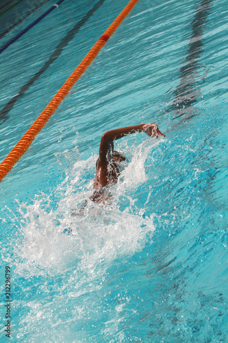 Swimmers swim free style, front crawl or forward crawl stroke in a swimming pool for competition or race © wibulpas