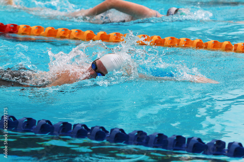 Swimmers swims free style in a swimming pool for competition or race
