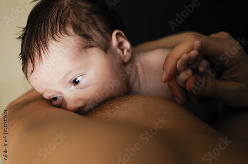 Картината върху платно Young mother breastfeeding newborn baby