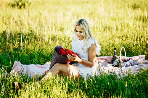 Beautiful blond woman enjoying a pick nick outdoors. Pick nick for one.