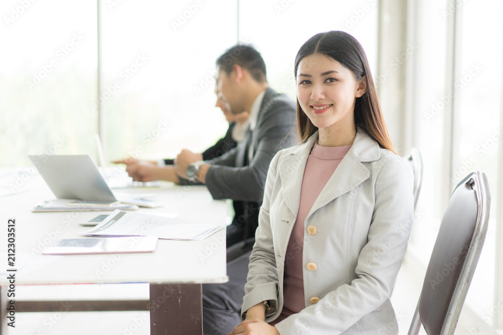 Modern business woman in the office with copy space.she sit down and smile. Modern business woman in the office with copy space.she sit down and smile.