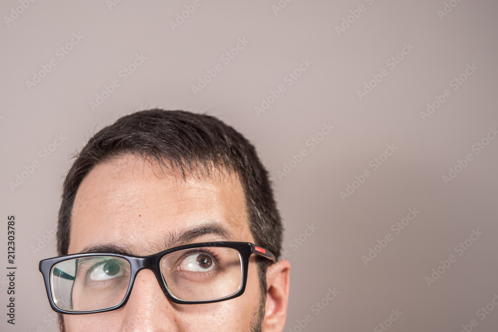 The doubtful thinking man, looks for a solution that looks up. Expression of the human face The doubtful thinking man, looks for a solution that looks up. Expression of the human face