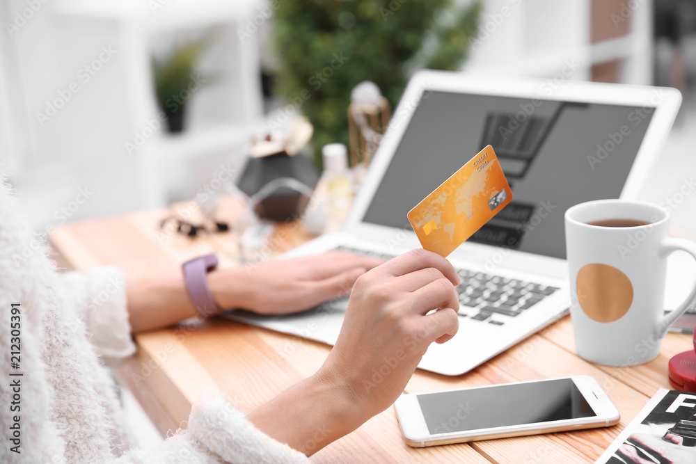 Young woman with credit card and laptop. Online shopping concept Young woman with credit card and laptop. Online shopping concept