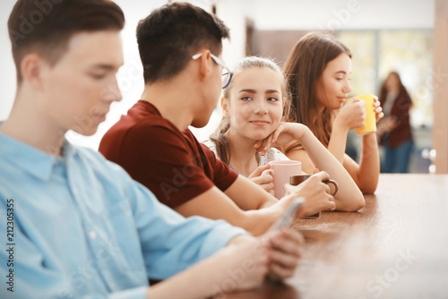 Cool teenagers resting in cafe