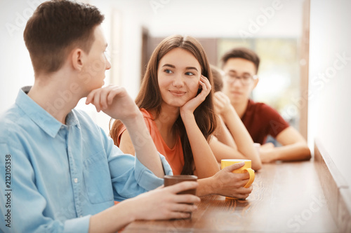 Cool teenagers resting in cafe