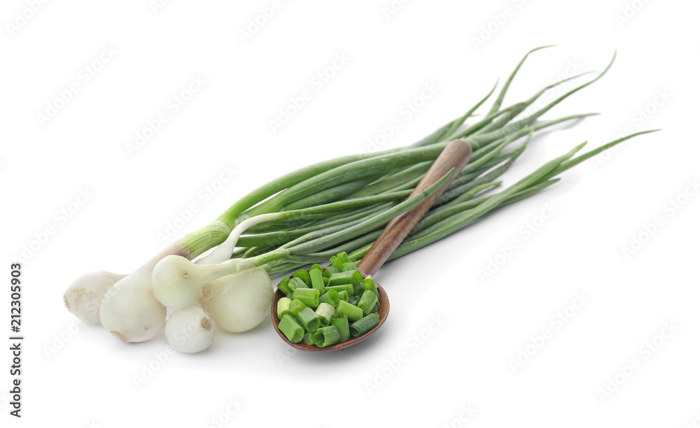 Obraz premium Spoon with chopped green onion and stems on white background
