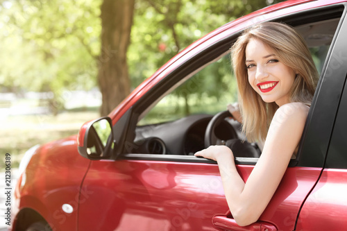 Young woman on driver's seat of car