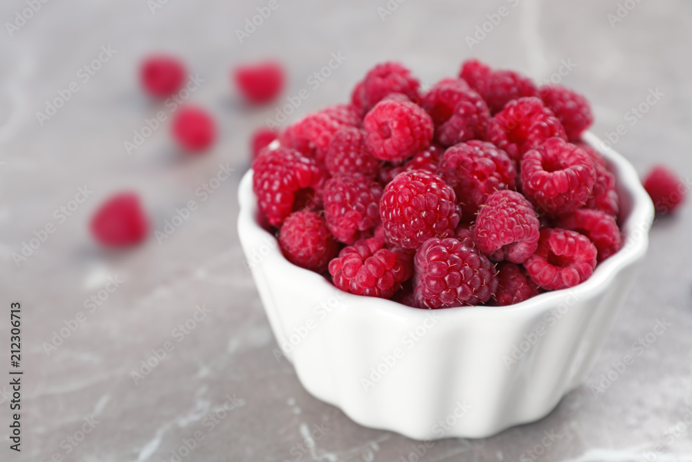 Bowl with ripe aromatic raspberries on table Bowl with ripe aromatic raspberries on table