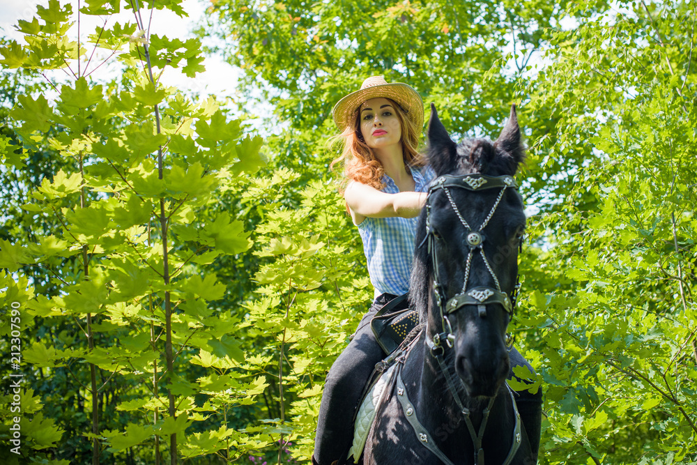 Nice american lady in a plaid shirt and hat. A beautiful rider gently hugs the horse. Artistic Photography at horse farm Nice american lady in a plaid shirt and hat. A beautiful rider gently hugs the horse. Artistic Photography at horse farm