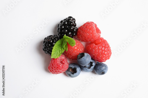 Raspberries  blackberries and blueberries on white background