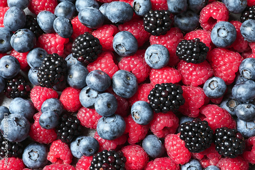Raspberries  blackberries and blueberries as background