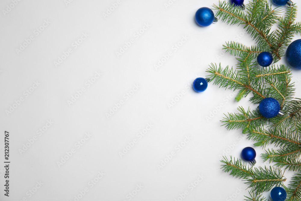 Fototapeta premium Composition with Christmas tree branches and festive decor on white background