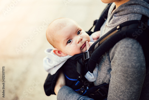 Bilde på lerret Little baby girl and her mother walking outside during sunset