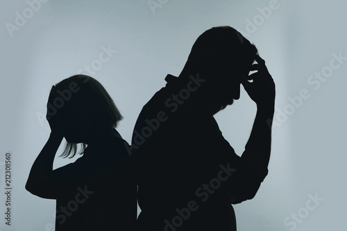 Fotografie Silhouette of couple having argument on color background