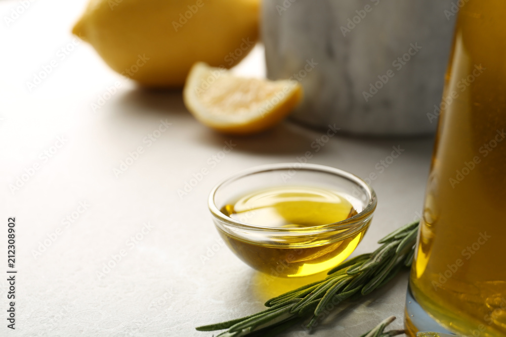 Small bowl of rosemary oil on table Small bowl of rosemary oil on table