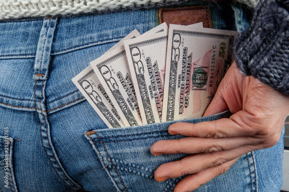 competition confirm torture Minimum wage concept - US 50 dollar bills in back pocket of jeans with  female hand Stock Photo | Adobe Stock