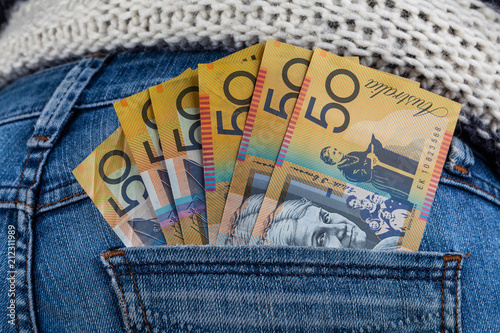 50 AUD bills in fan shape placed in female jeans back pocket