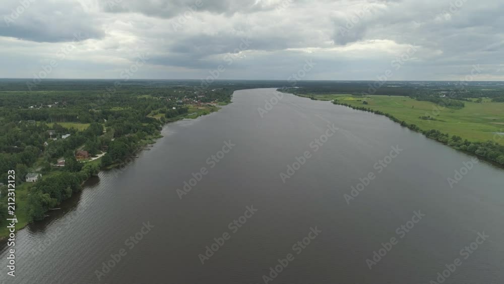 Aerial view summer landscape, river Volga in countryside banks river are covered with greenery, against the sky and clouds. Aerial view summer landscape, river Volga in countryside banks river are covered with greenery, against the sky and clouds.