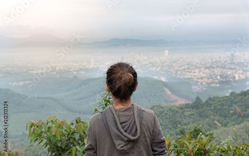 Back view of asian woman relaxing on the top hill. © ichz
