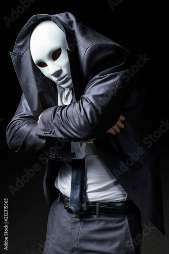 Masked man in dark and black suit