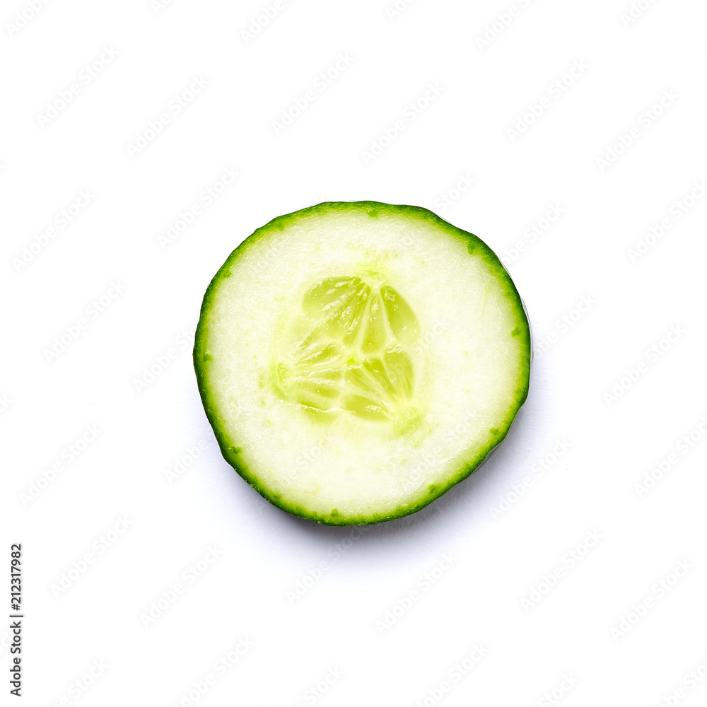 A slice of Cucumber on White Background. Close up. Top view. A slice of Cucumber on White Background. Close up. Top view.