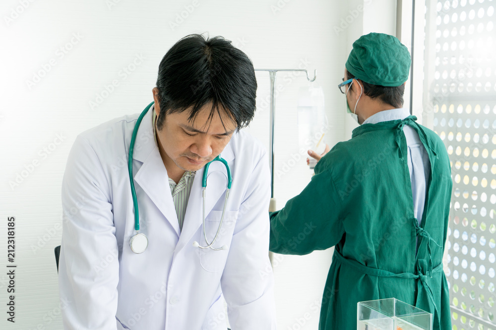 Team expert doctors meeting plan for operation plan at doctor office desk. Teamwork, corporation and meeting concept. Team expert doctors meeting plan for operation plan at doctor office desk. Teamwork, corporation and meeting concept.