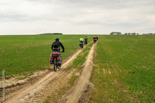 Bicyclists in roughed field in Nizhny Novgorod Region, Russia