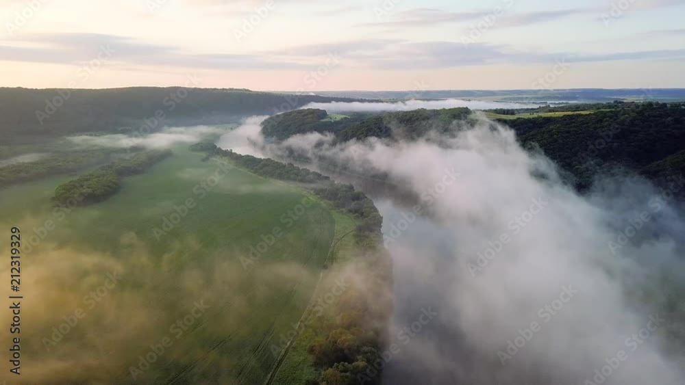 River and field in the mist during sunrise. Natural aerial landscape at the summer time River and field in the mist during sunrise. Natural aerial landscape at the summer time
