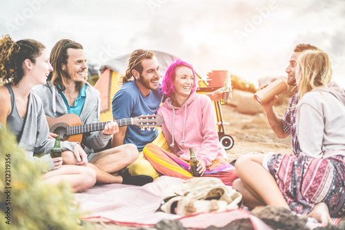 Group of happy friends making barbecue party on the beach