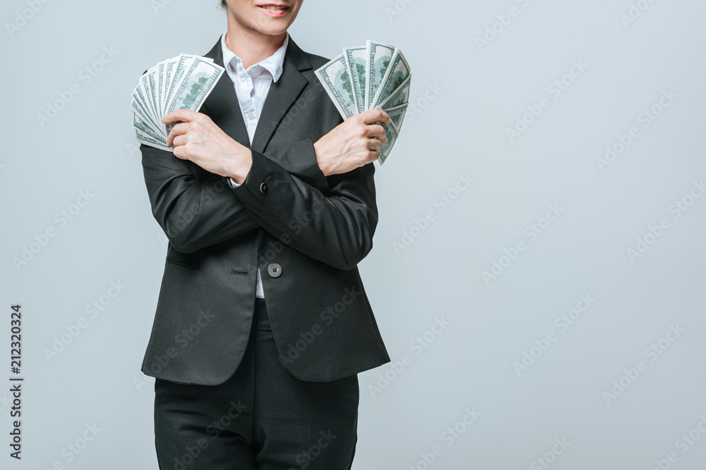 cropped image of financier holding dollars in hands isolated on grey cropped image of financier holding dollars in hands isolated on grey