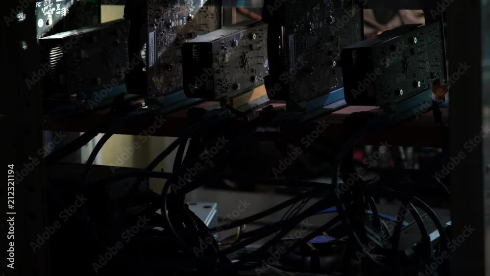 The programmer shines a flashlight in the computer farm for mining crypto-currency