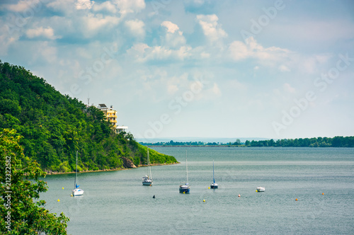 Yachts in harbor of Zemplinska Sirava lake, Slovakia. sailboats stand still, safe vacation in summer photo