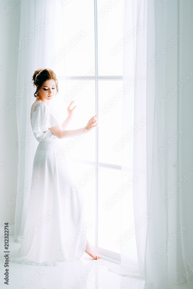 Tender elegant young bride with hairdo, hairpin and bridal makeup Tender elegant young bride with hairdo, hairpin and bridal makeup