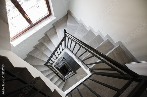 фотографія Look from above at the stairways going down as the spiral