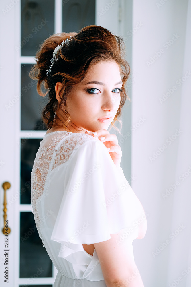 Tender elegant young bride with hairdo, hairpin and bridal makeup Tender elegant young bride with hairdo, hairpin and bridal makeup