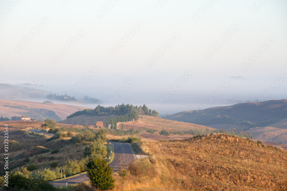 Crete Senesi landscape in Tuscany, Italy on a foggy dawn