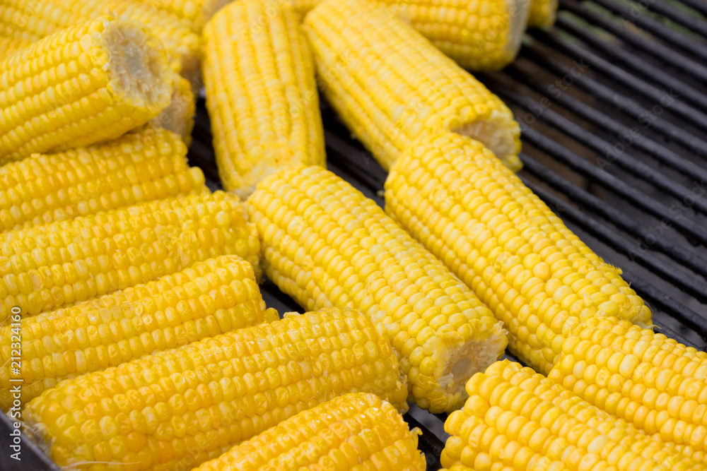 Delicious sweet corn cobs on pan Delicious sweet corn cobs on pan