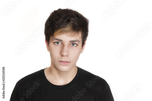 A teenager with a serious face and a black T-shirt on a white background