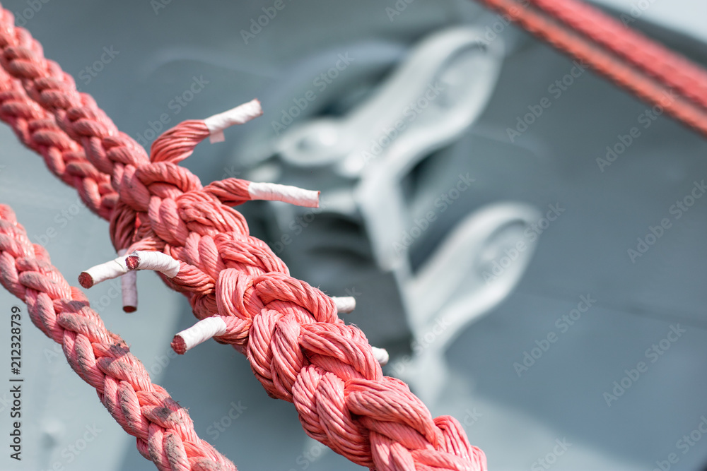 Obraz premium Ship mooring rope on the port wharf. Harbor bollard for large naval vessels.