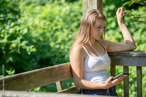 Teenage girl with headphones listening to her phone