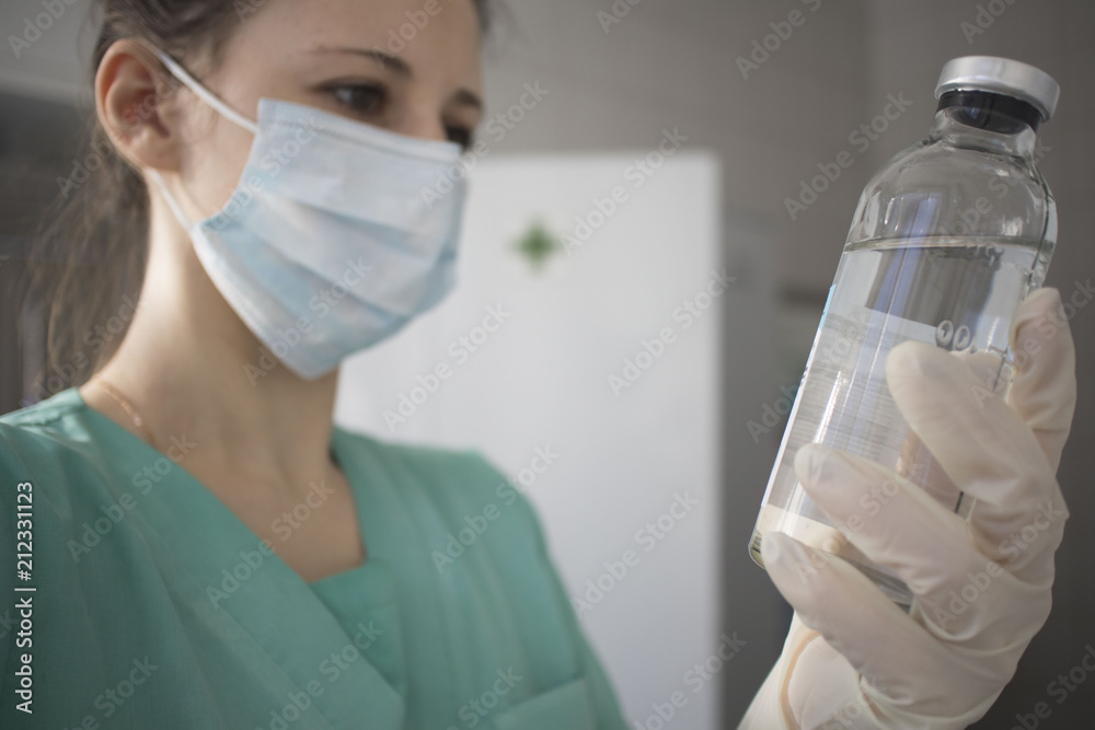 woman doctor in gauze holding a flask with medicine, medicine concept woman doctor in gauze holding a flask with medicine, medicine concept