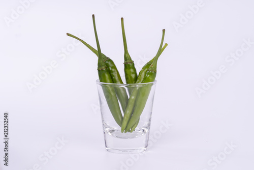 Close up red hot chilli pepper in a clear glass on isolated white background  focus stacking and clipping path.