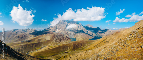 Panoramic view of Gangabal lakes in dry season from Zajibal Pass (4,100m) with blue sky in background from Kashmir The Great Lakes Trek, India.
